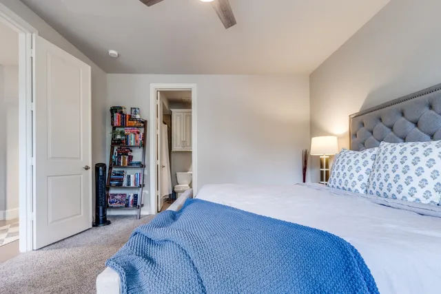 a bedroom with a bed and a book shelf