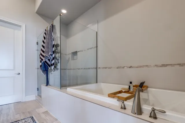 a bathroom with a bathtub and a shower