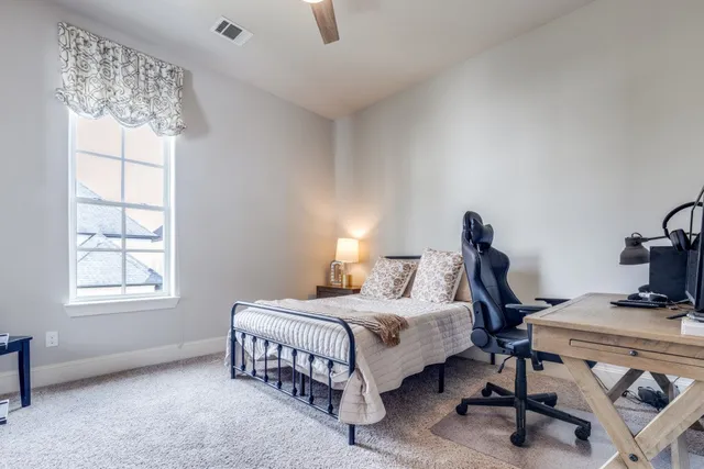 a bedroom with a bed and a table in it