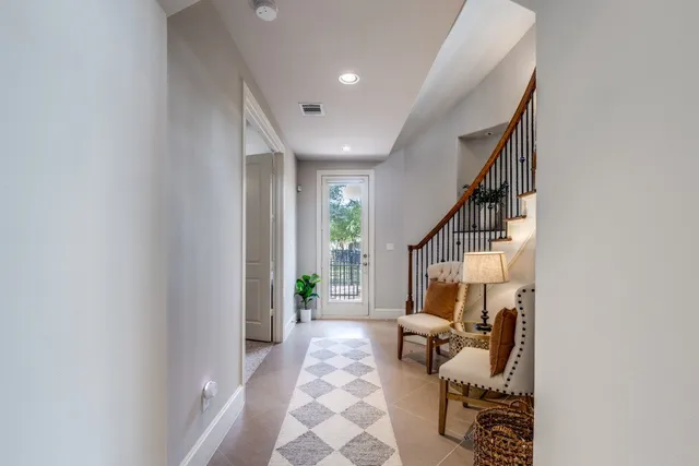 a living room with furniture and stairs