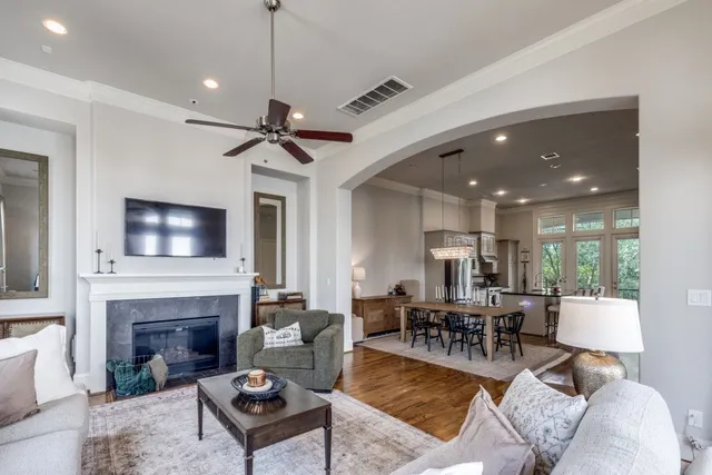 a living room with furniture a fireplace and a flat screen tv