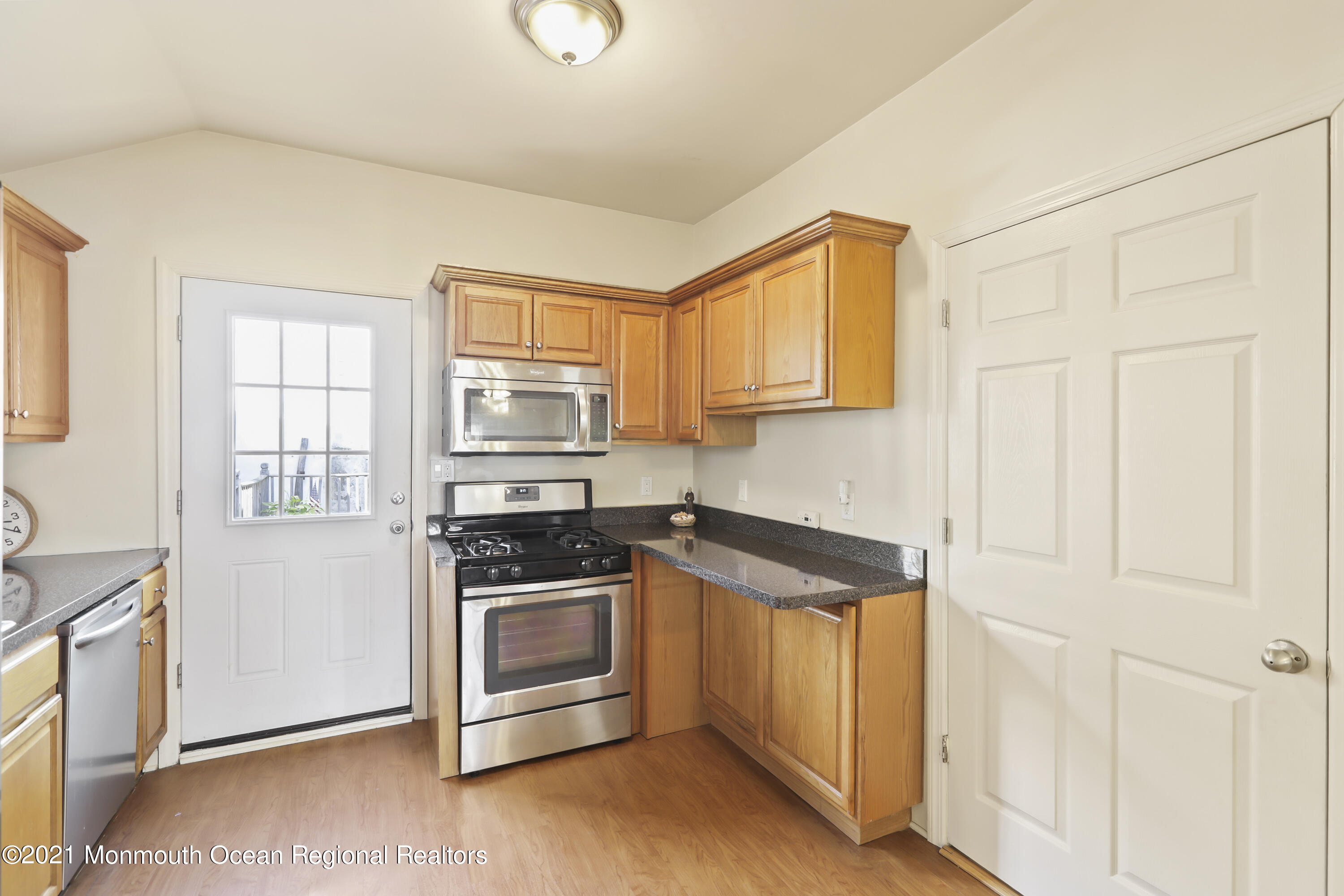 21 Center Street Sea Bright, NJ 07760 - Photo 6 of 21 a kitchen with stainless steel appliances granite countertop a stove a sink and a microwave