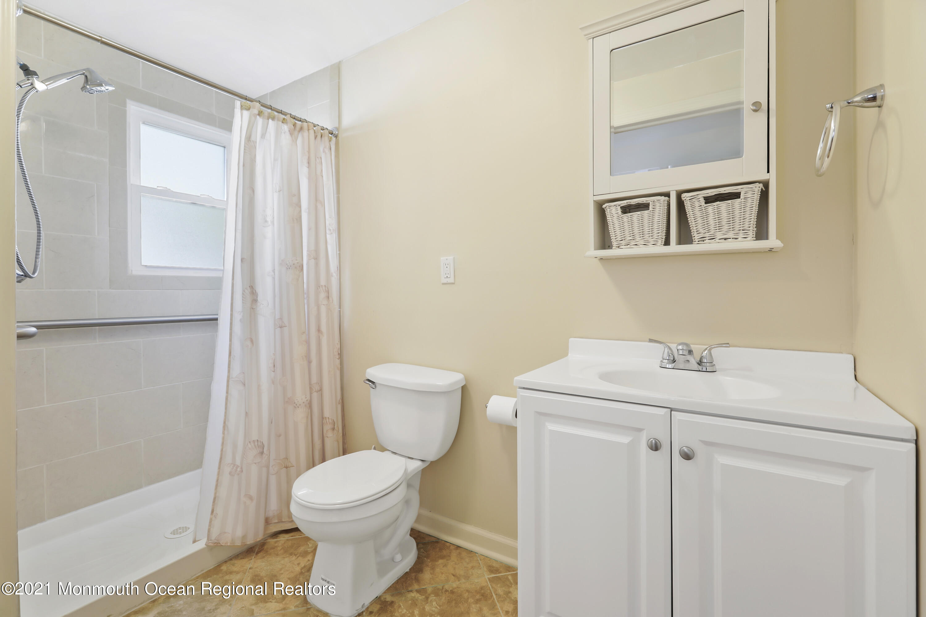 21 Center Street Sea Bright, NJ 07760 - Photo 7 of 21 a bathroom with a sink a toilet and shower