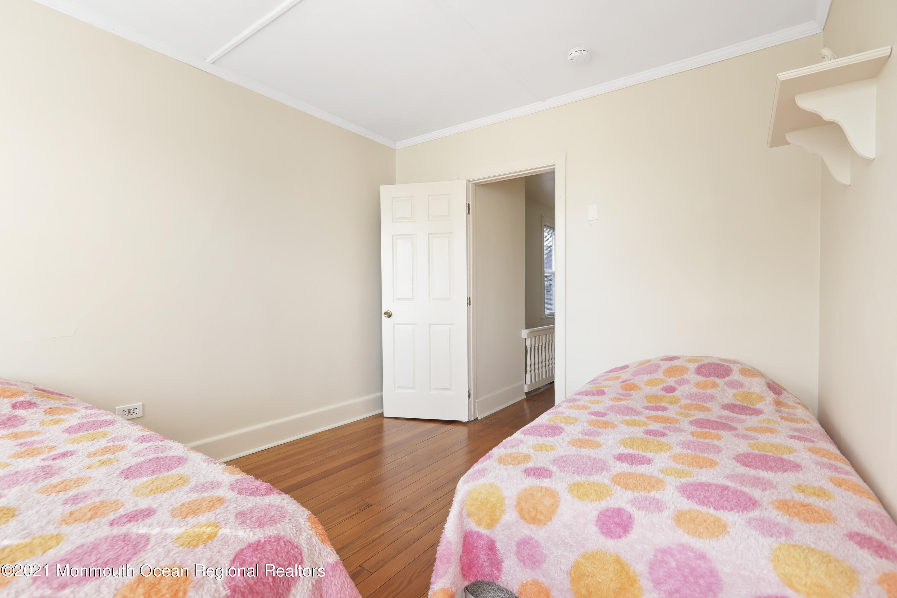 21 Center Street Sea Bright, NJ 07760 - Photo 10 of 21 a bedroom with a bed and wooden floor
