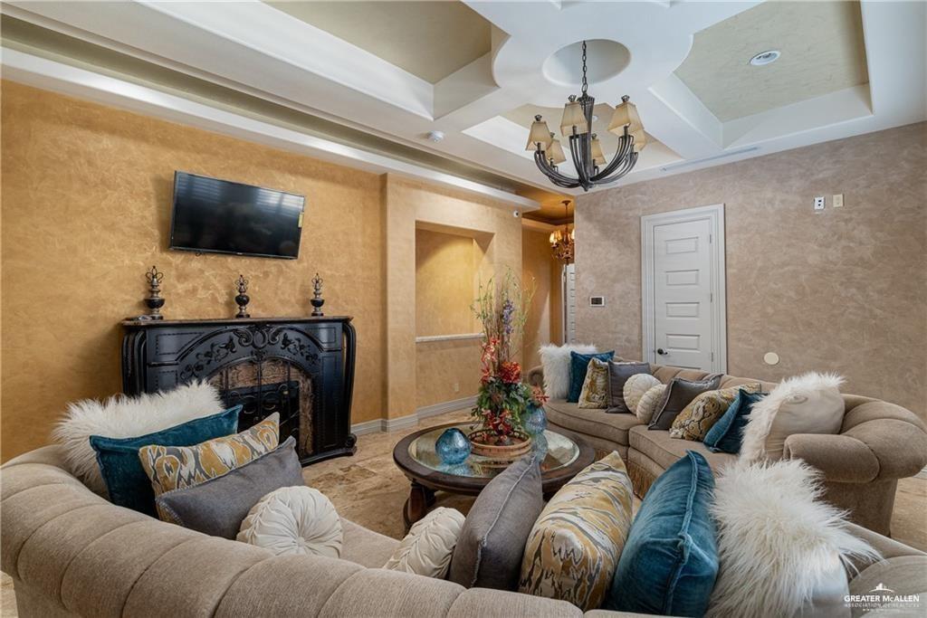 1205 Travis Street Mission, TX 78572 - Photo 23 of 45 a living room with furniture and a flat screen tv