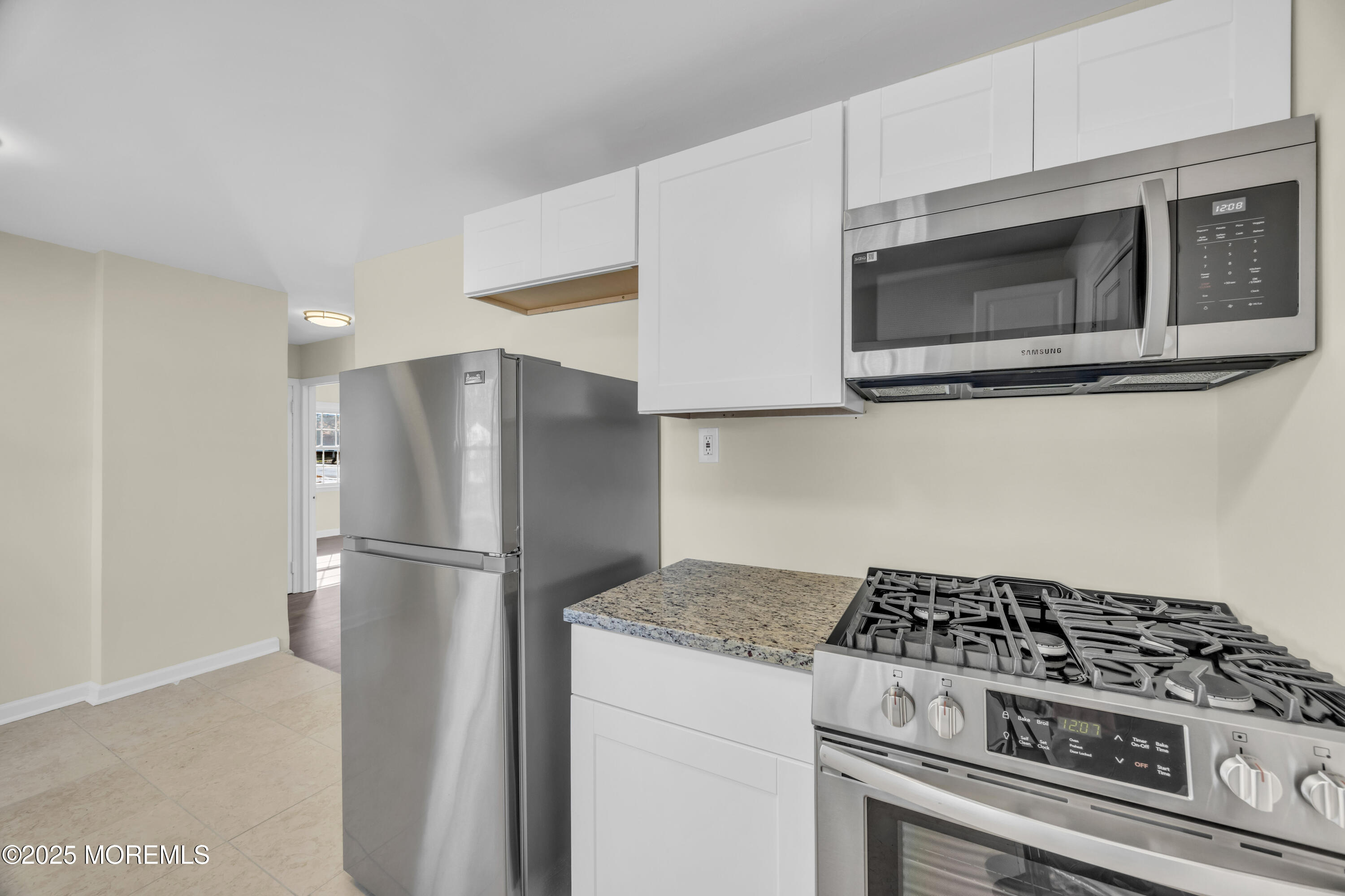 11 Randolphville Road Piscataway, NJ 08854 - Photo 13 of 27 a kitchen with stainless steel appliances white cabinets and stove