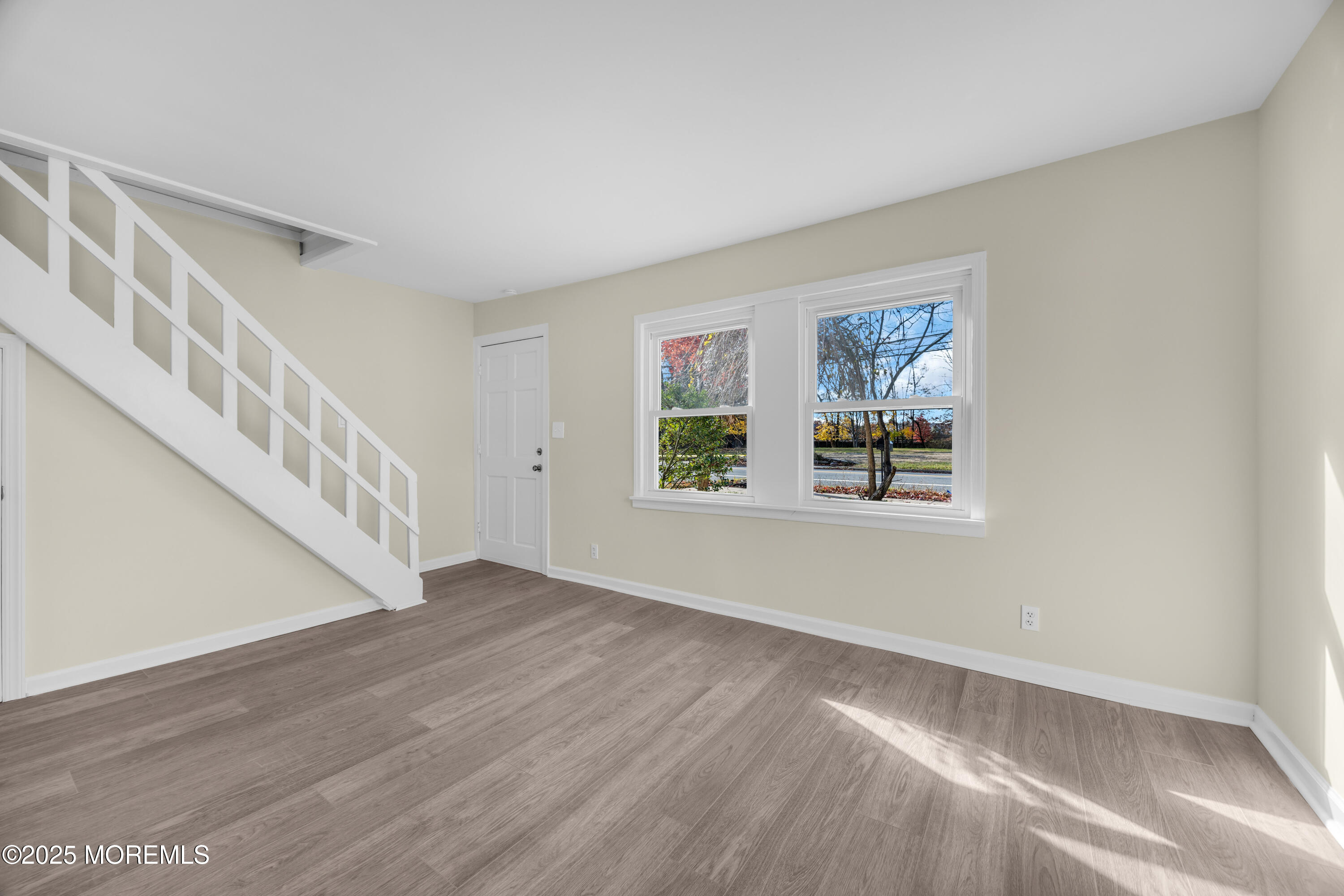 11 Randolphville Road Piscataway, NJ 08854 - Photo 4 of 27 a view of an empty room with wooden floor and a window