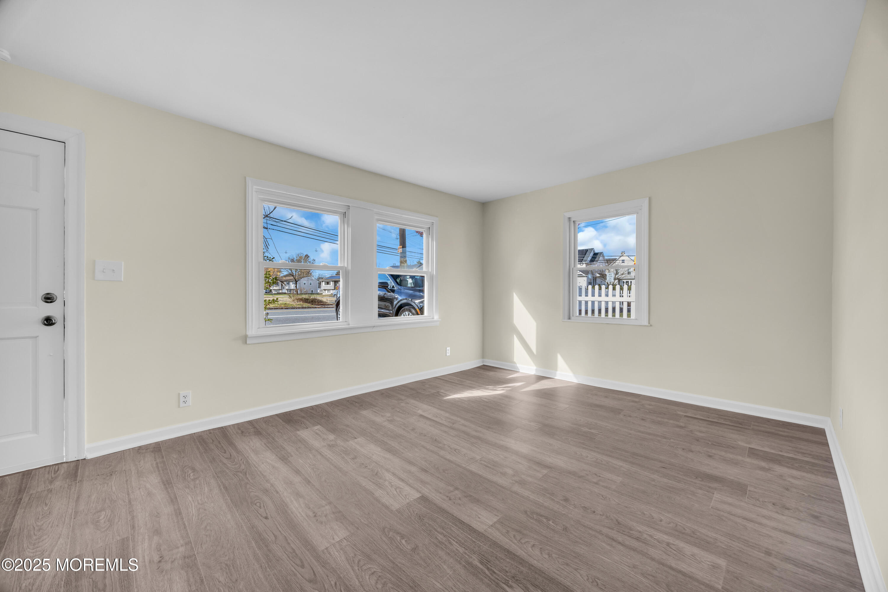 11 Randolphville Road Piscataway, NJ 08854 - Photo 5 of 27 a view of an empty room with wooden floor and a window