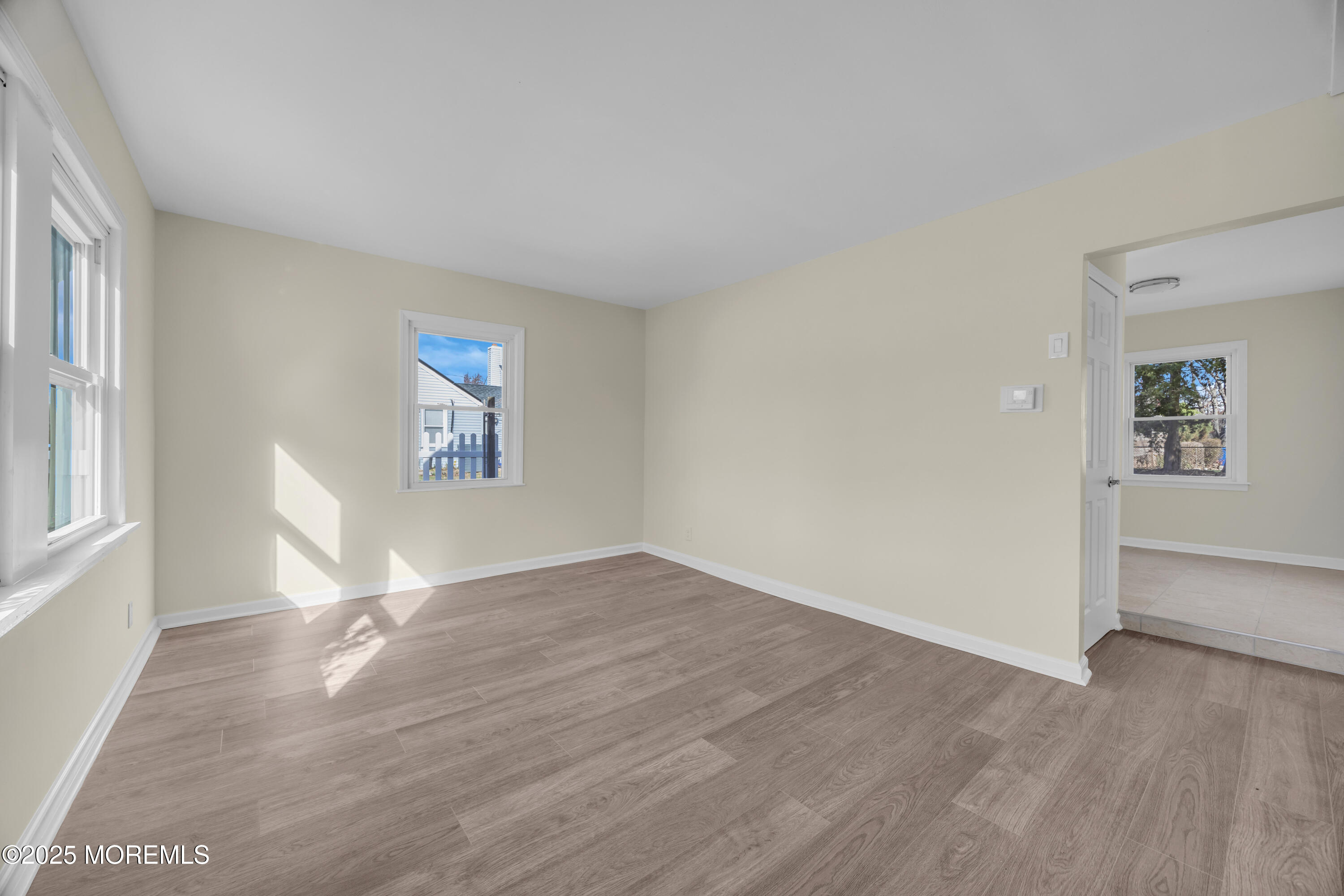 11 Randolphville Road Piscataway, NJ 08854 - Photo 7 of 27 an empty room with wooden floor and windows