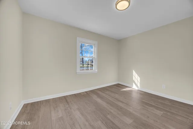 a room that has a window and a wooden floor