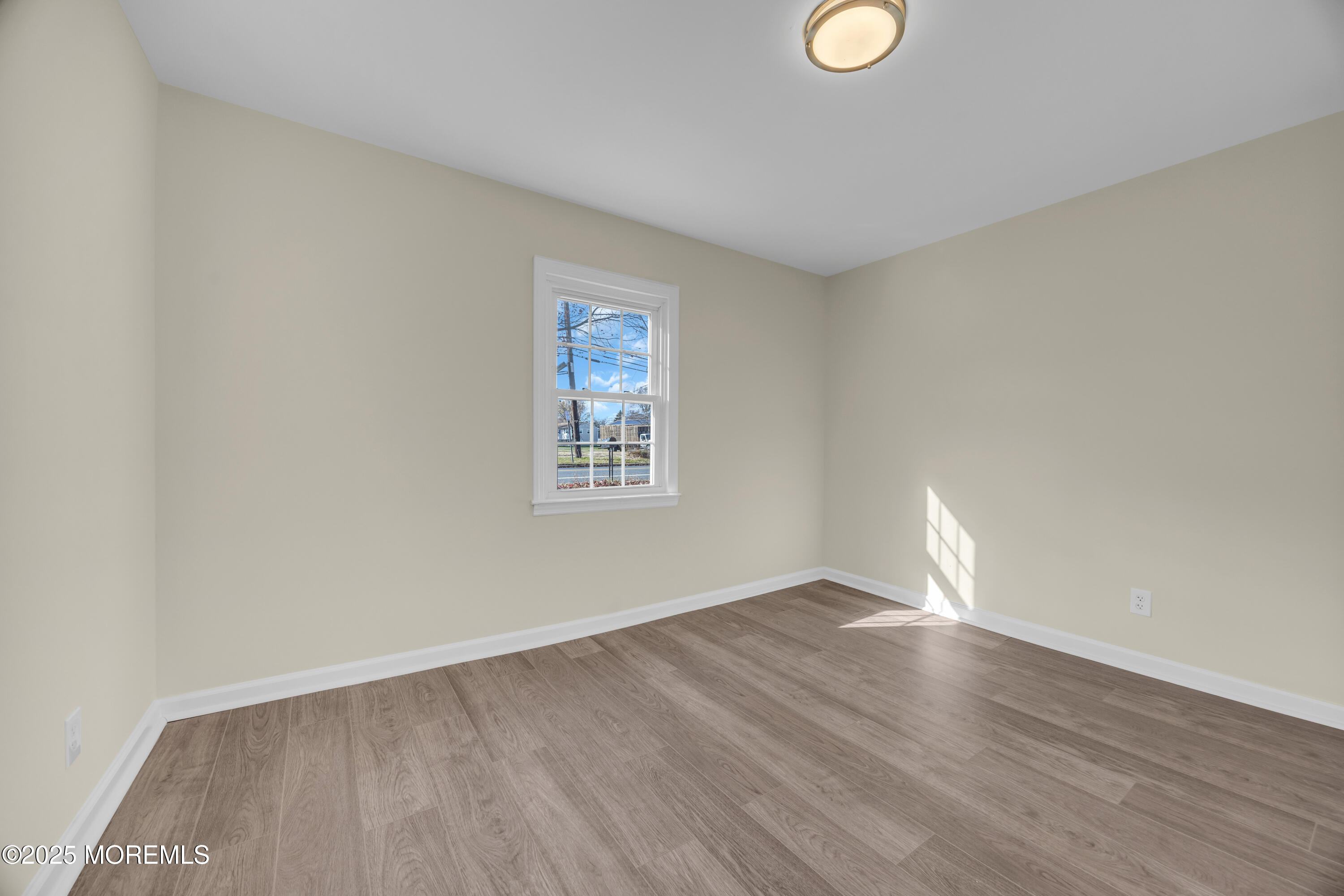 11 Randolphville Road Piscataway, NJ 08854 - Photo 9 of 27 a view of an empty room with wooden floor and a window