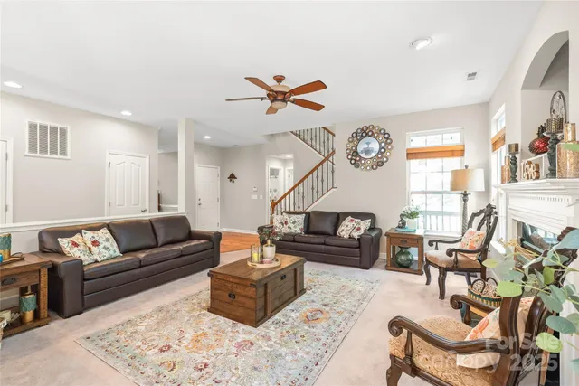 a living room with furniture ceiling fan and a rug