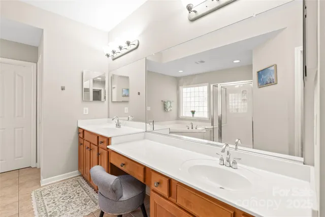 a spacious bathroom with a sink double vanity and a mirror