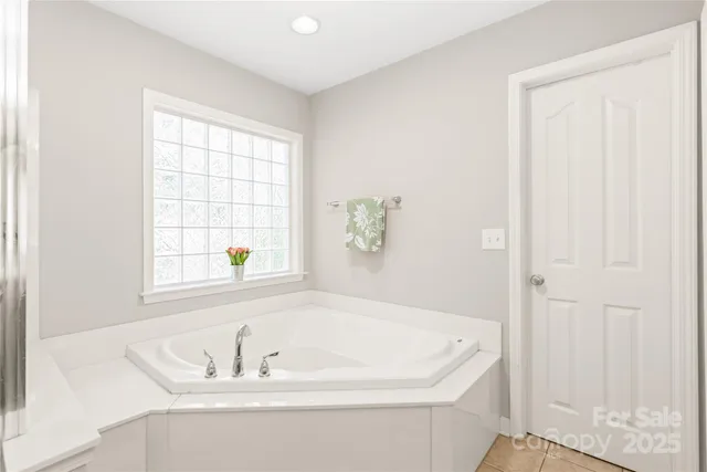 a white bath tub sitting next to a window