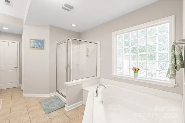 a bathroom with a bathtub and a shower