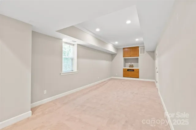 an empty room with a window and fireplace