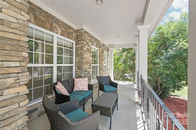 a view of a patio with couches chairs and potted plants
