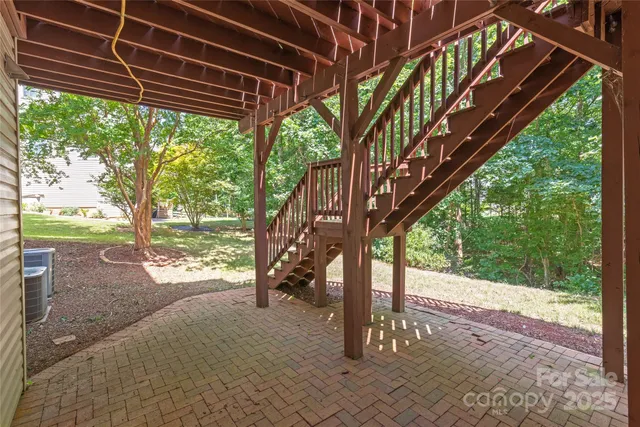 a view of a backyard with a large tree