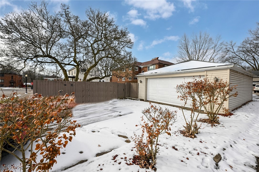 1164 Copley Road Akron, OH 44320 - Photo 50 of 50 Yard covered in snow with a garage, an outbuilding, and fence
