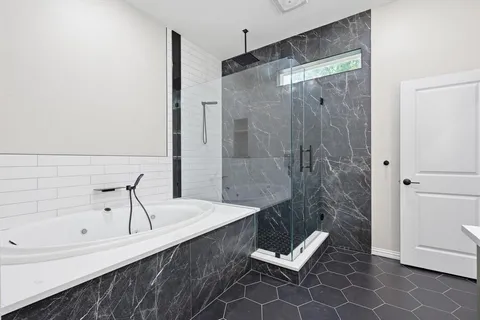 a bathroom with a tub and a sink