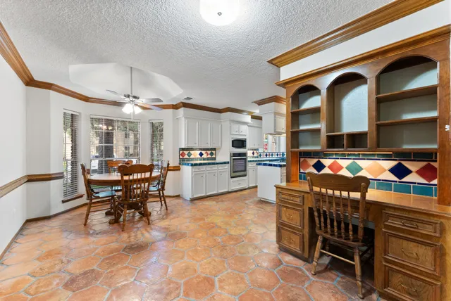 a view of a dining area with furniture and a kitchen