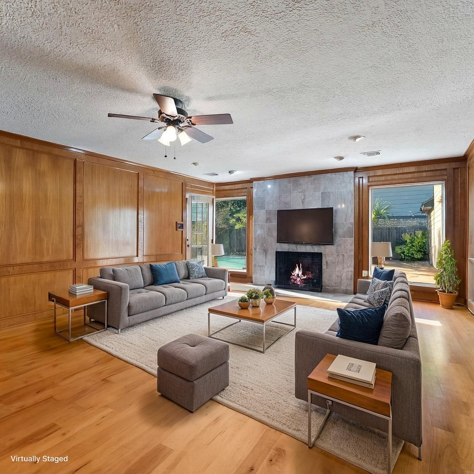 5718 Glenmere Lane Spring, TX 77379 - Photo 19 of 43 a living room with furniture ceiling fan and a fireplace
