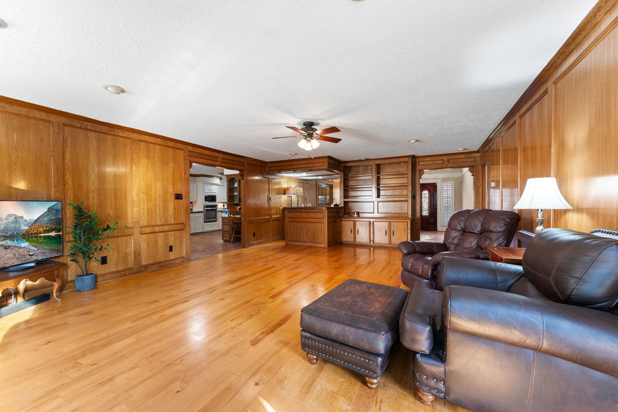 5718 Glenmere Lane Spring, TX 77379 - Photo 20 of 43 a living room with furniture and a wooden floor