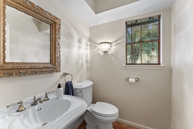 a bathroom with a sink mirror and toilet