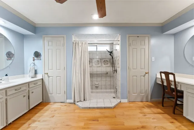 a spacious bathroom with a mirror a sink and a shower