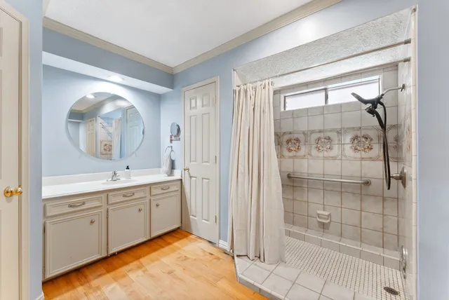 a large bathroom with a glass door shower and sink