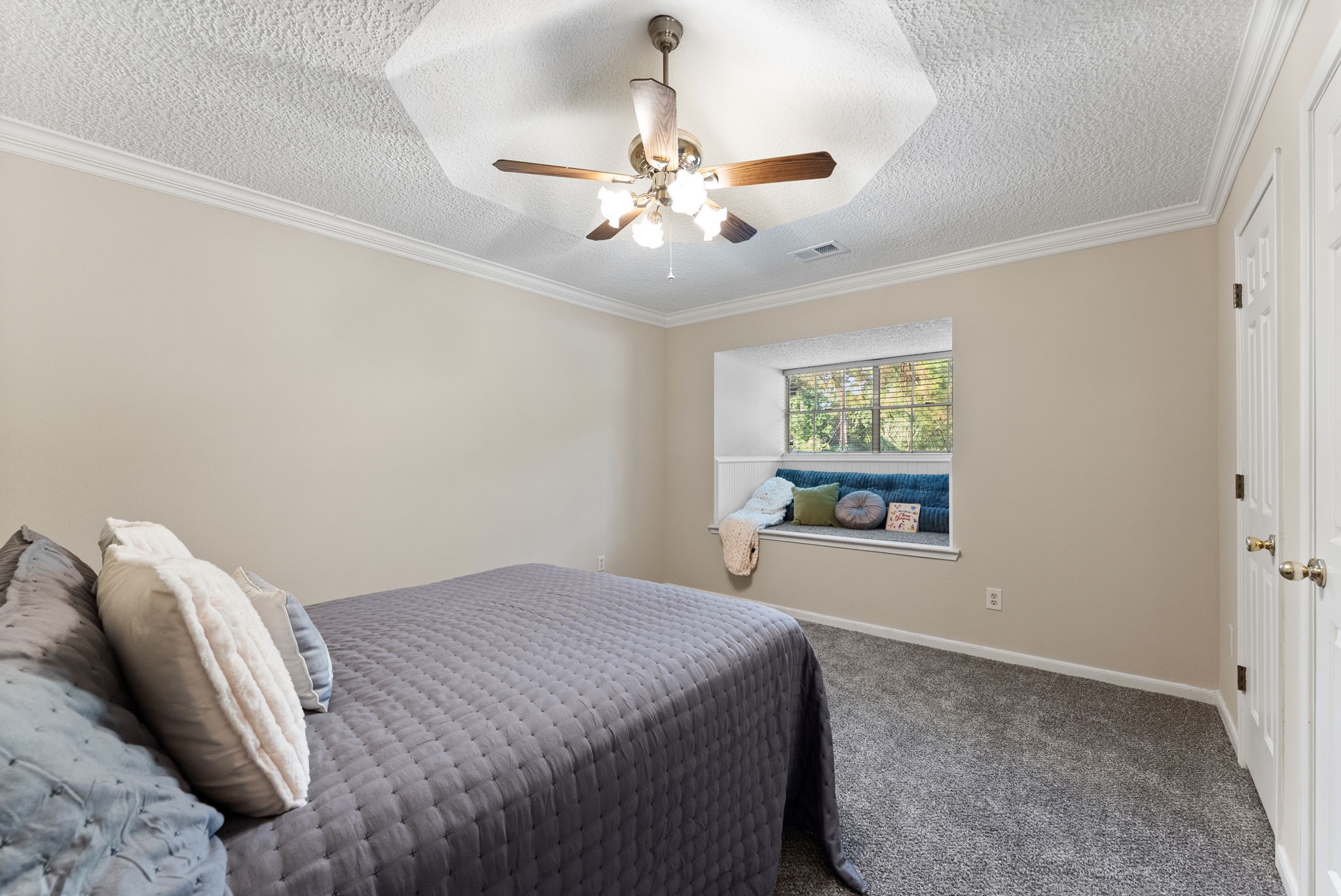 5718 Glenmere Lane Spring, TX 77379 - Photo 27 of 43 a bedroom with a bed and a chandelier