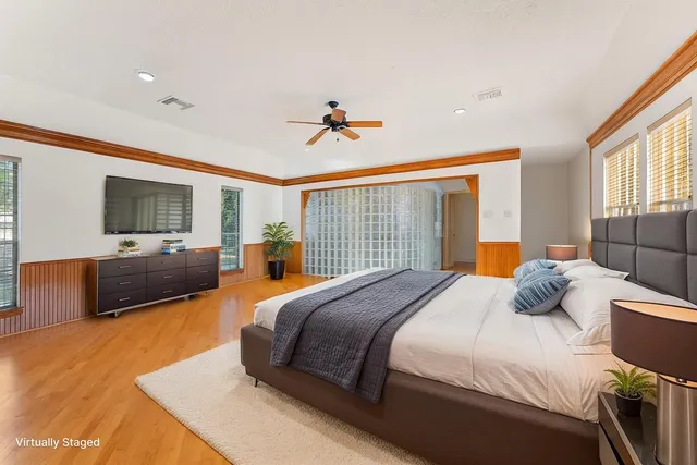 a bedroom with a balcony a bed and a flat screen tv