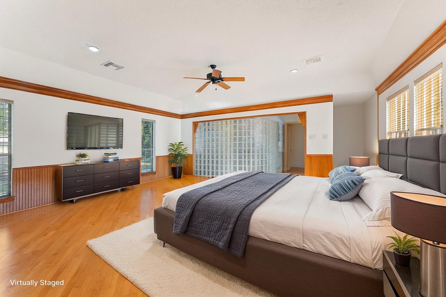 5718 Glenmere Lane Spring, TX 77379 - Photo 32 of 43 a bedroom with a balcony a bed and a flat screen tv