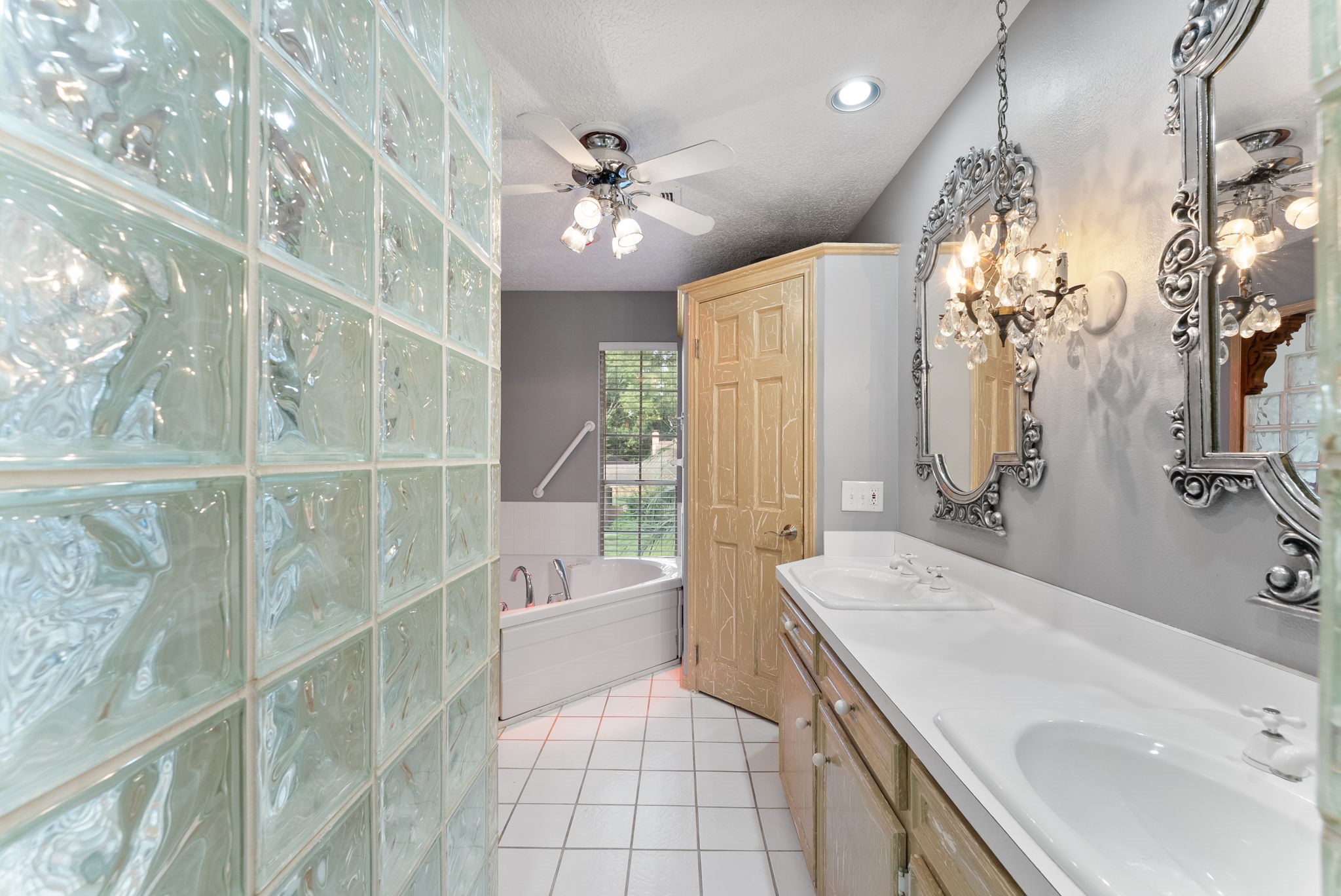 5718 Glenmere Lane Spring, TX 77379 - Photo 33 of 43 a spacious bathroom with a sink a large mirror and shower