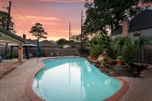 a view of a swimming pool with a patio