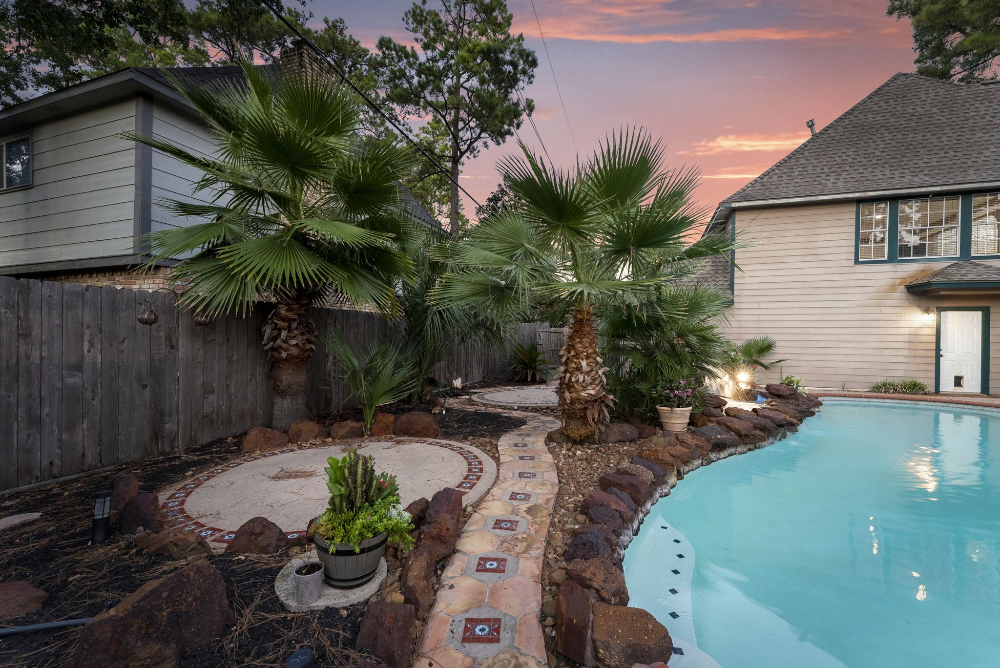 5718 Glenmere Lane Spring, TX 77379 - Photo 40 of 43 a backyard of a house with table and chairs potted plants