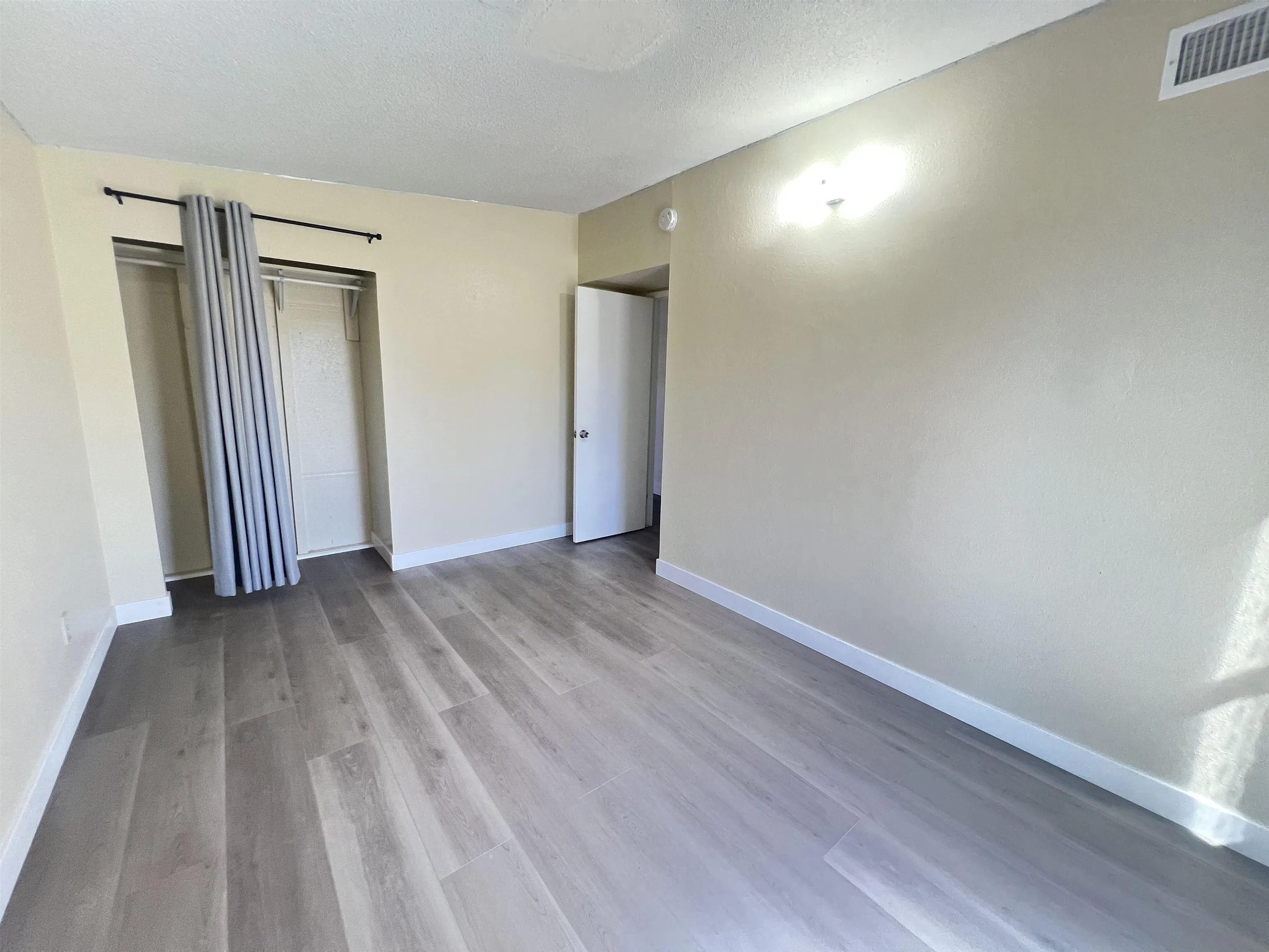 9267 Fairlawn Street Santee, CA 92071 - Photo 11 of 12 an empty room with wooden floor and a window