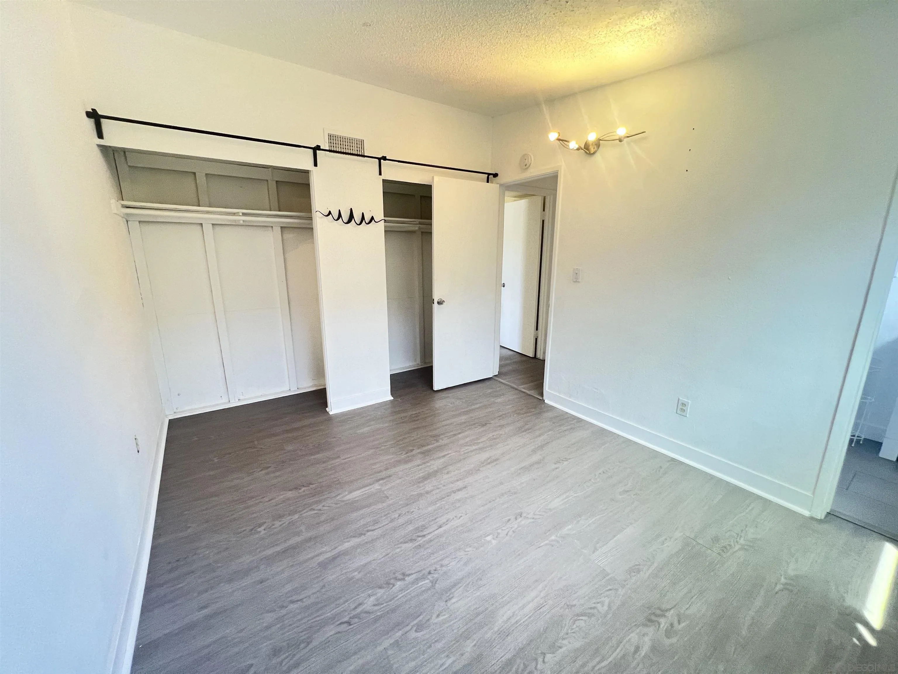 9267 Fairlawn Street Santee, CA 92071 - Photo 8 of 12 a view of empty room with wooden floor