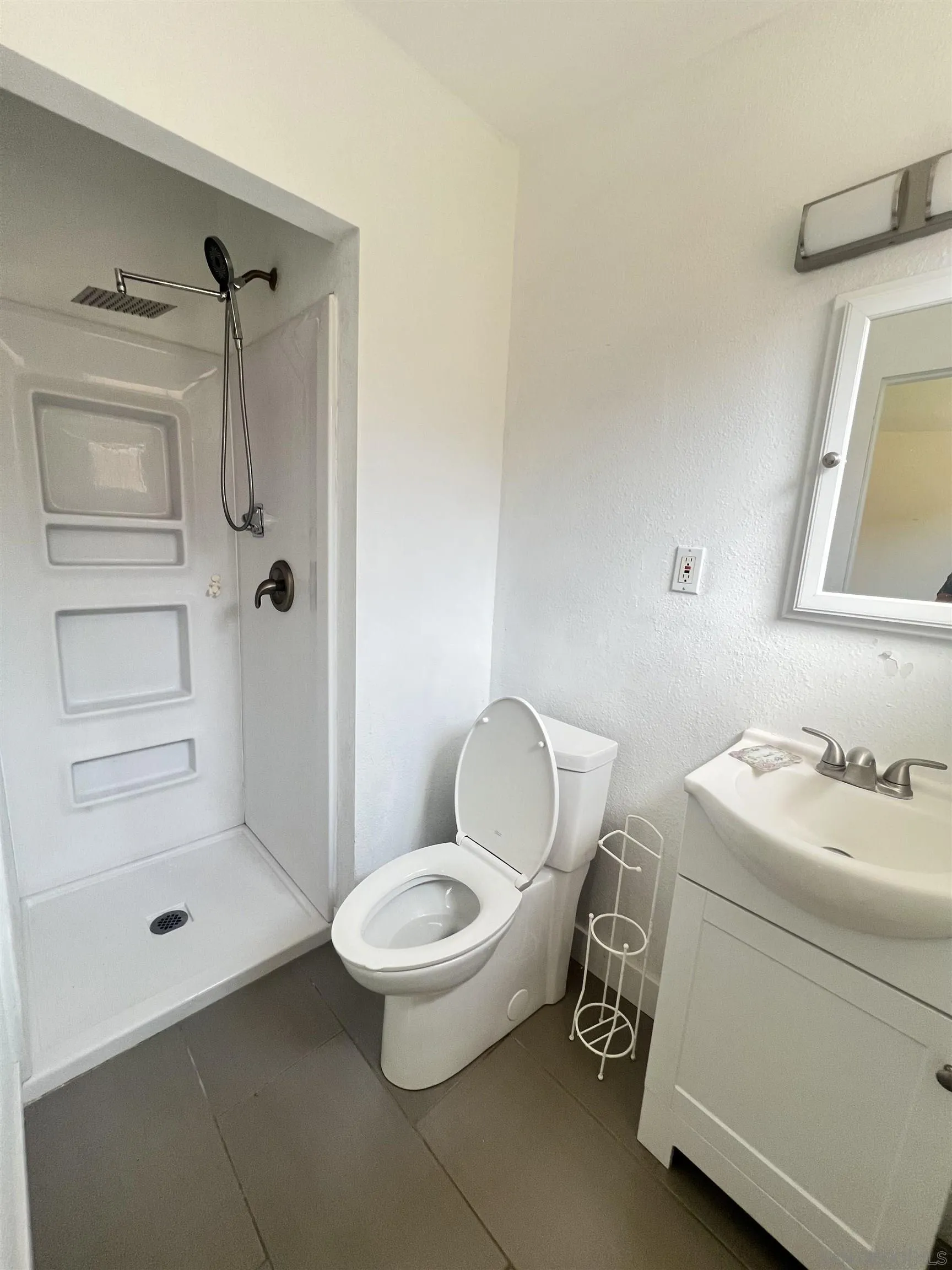 9267 Fairlawn Street Santee, CA 92071 - Photo 9 of 12 a bathroom with a toilet a sink and shower