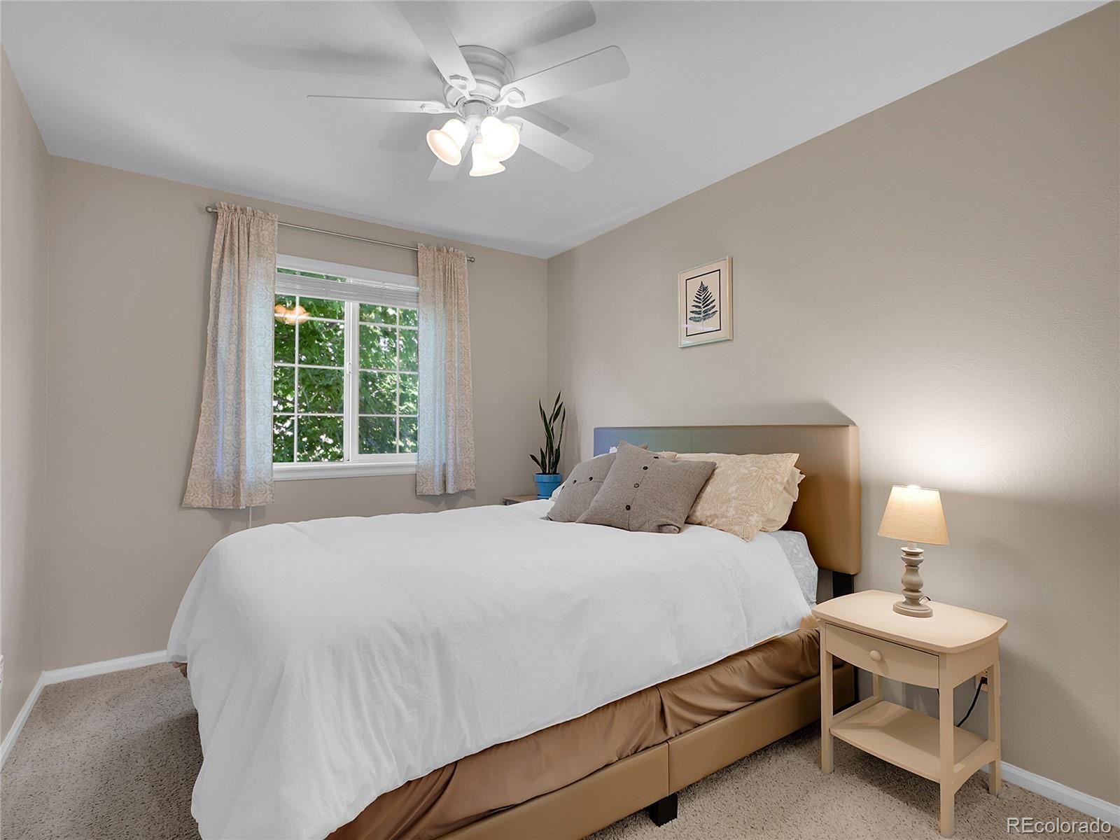 1234 Riddlewood Lane Highlands Ranch, CO 80129 - Photo 17 of 25 a bedroom with a bed and a window