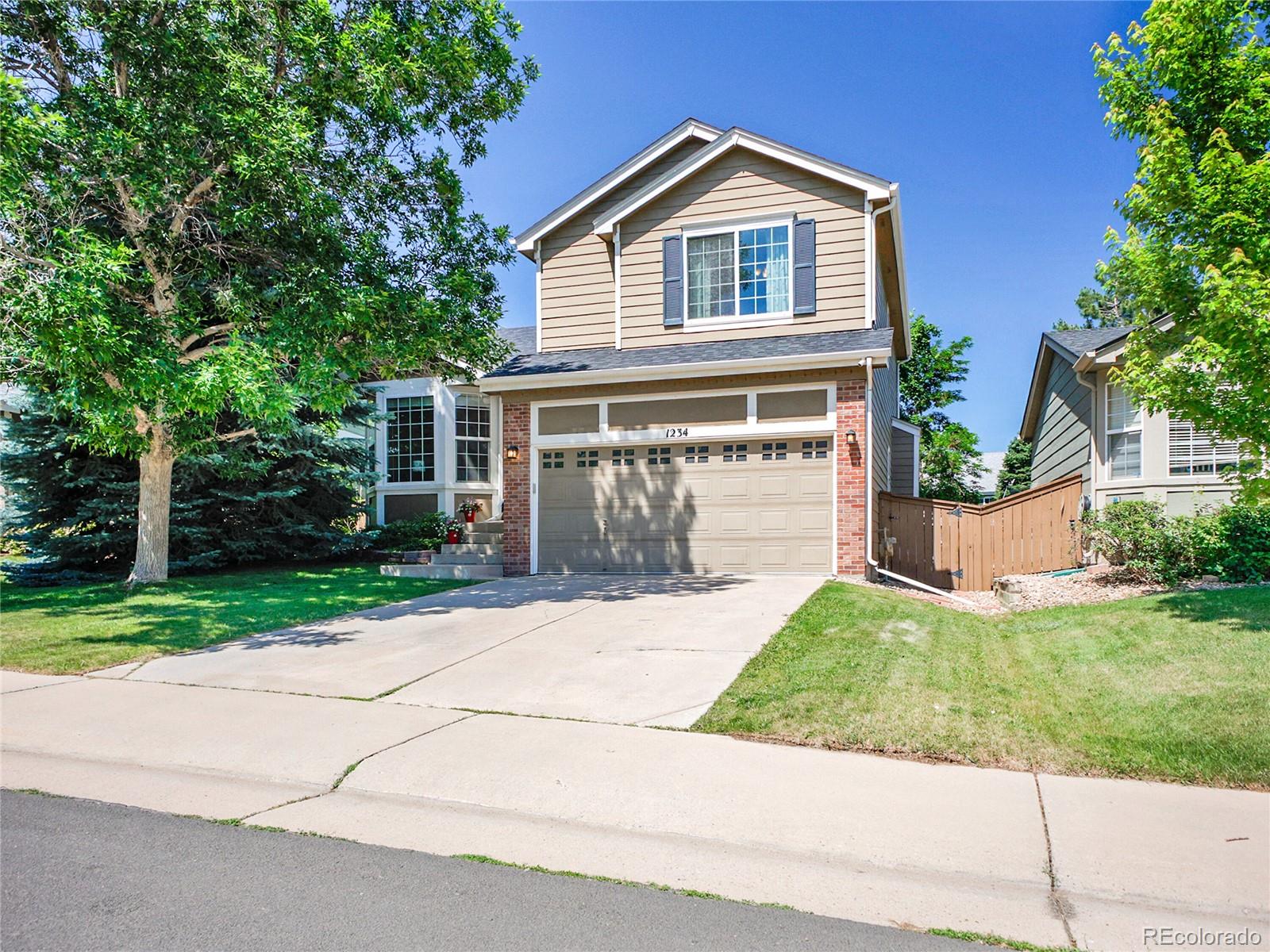 1234 Riddlewood Lane Highlands Ranch, CO 80129 - Photo 2 of 25 front view of a house with a yard