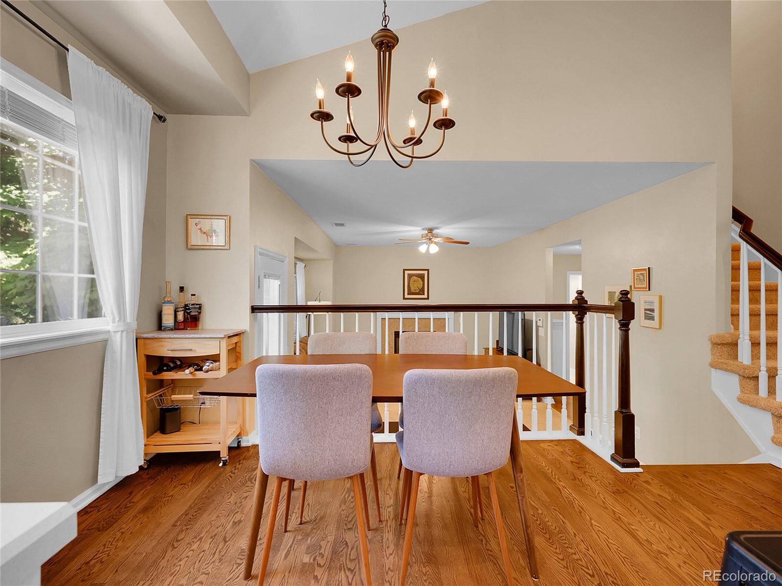 1234 Riddlewood Lane Highlands Ranch, CO 80129 - Photo 7 of 25 a view of a dining room with furniture a chandelier and wooden floor