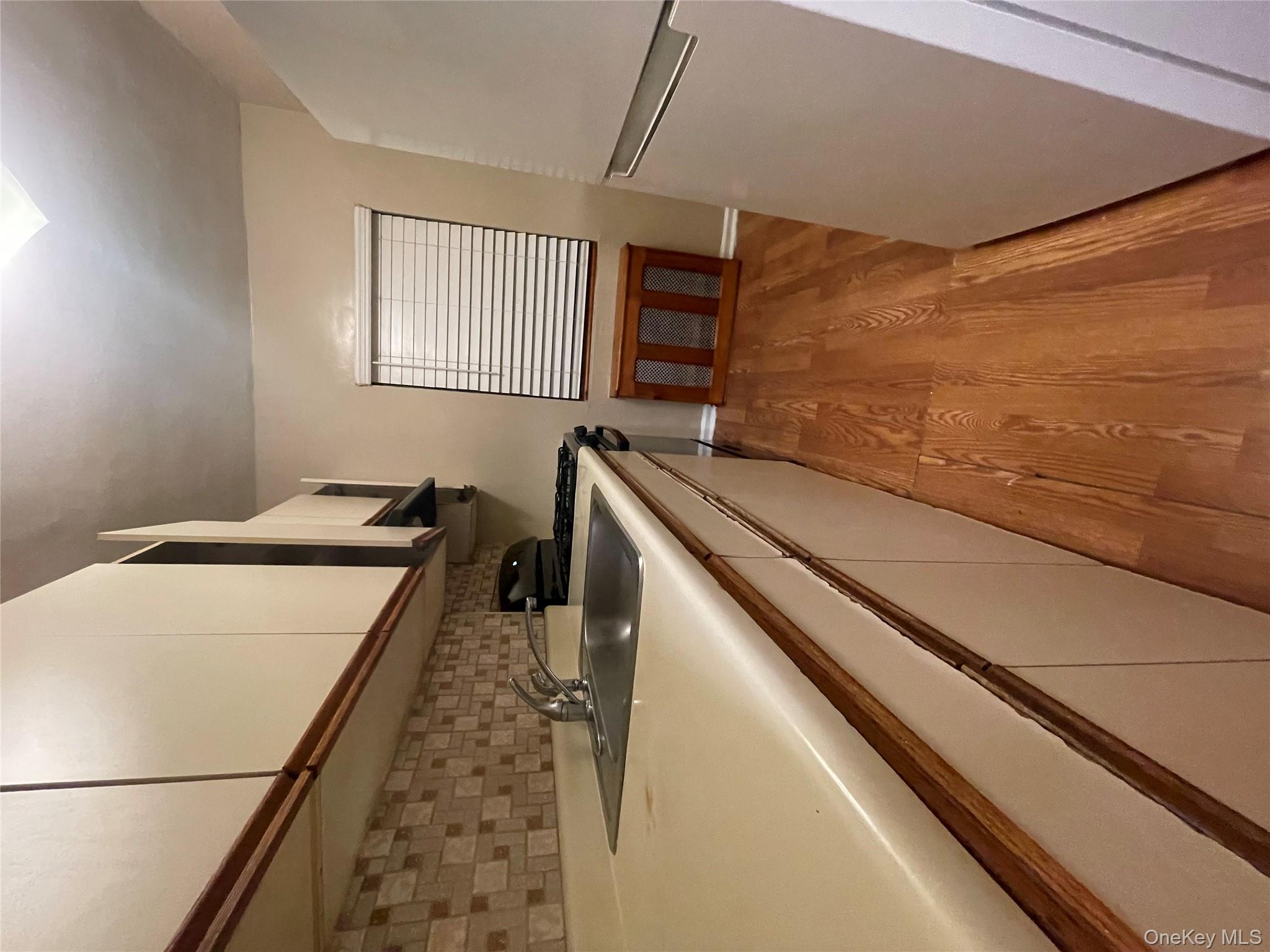 196-61 69th Avenue, Unit 1 Queens, NY 11365 - Photo 5 of 13 a view of a kitchen with a sink and dishwasher