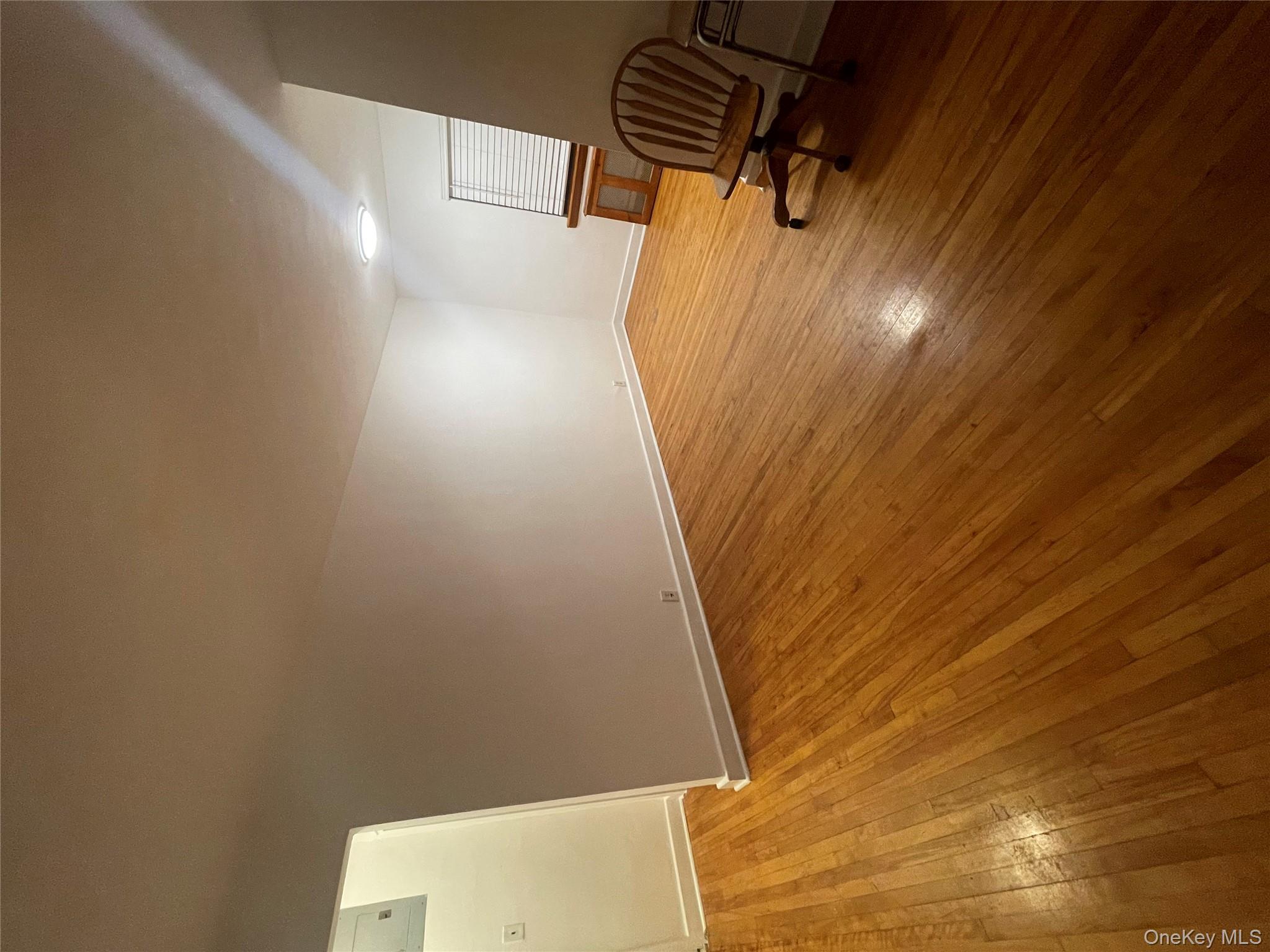 196-61 69th Avenue, Unit 1 Queens, NY 11365 - Photo 7 of 13 a view of a livingroom with wooden floor and a barbeque grill