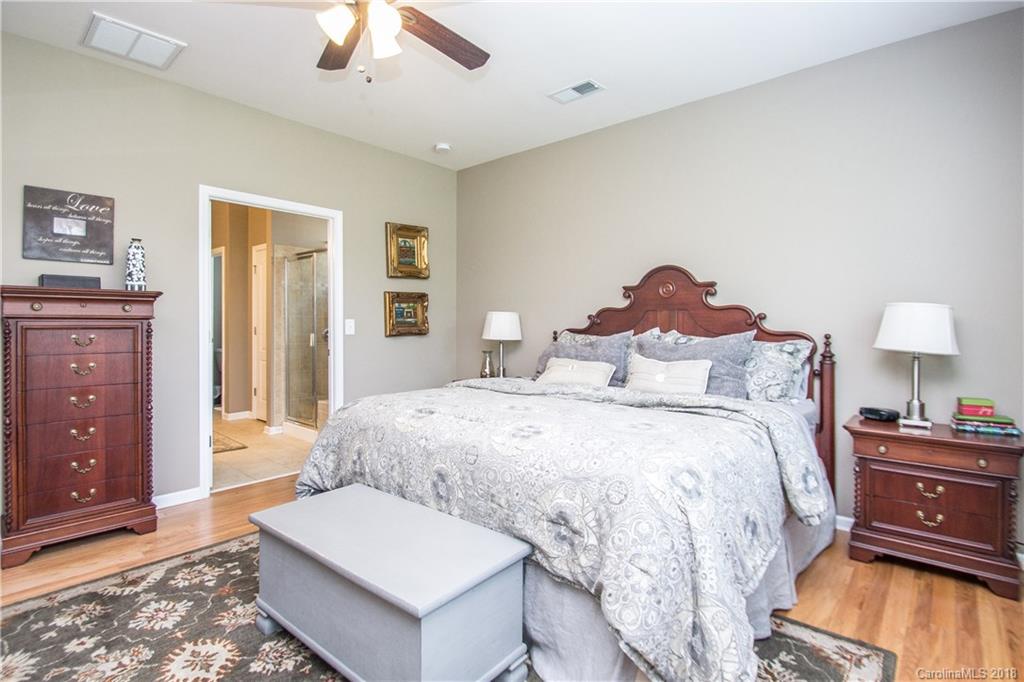 4016 Perth Road Indian Land, SC 29707 - Photo 13 of 28 a spacious bedroom with a bed and a chandelier