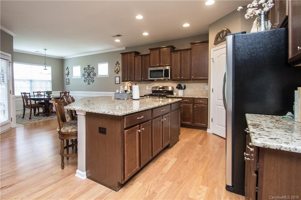 4016 Perth Road Indian Land, SC 29707 - Photo 8 of 28 a kitchen with kitchen island granite countertop a sink refrigerator and cabinets