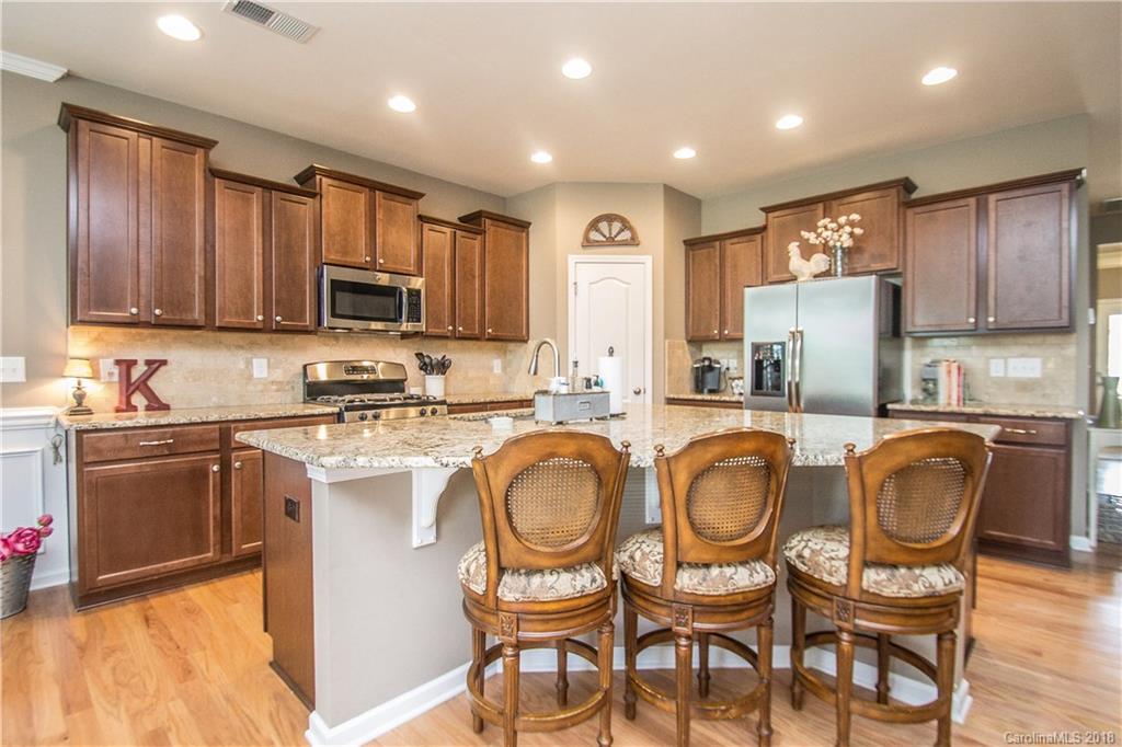 4016 Perth Road Indian Land, SC 29707 - Photo 10 of 28 a kitchen with kitchen island granite countertop wooden cabinets and stainless steel appliances