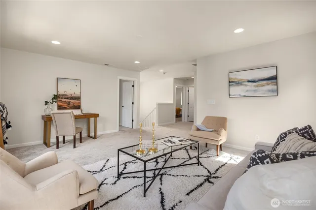 a living room with furniture and kitchen view