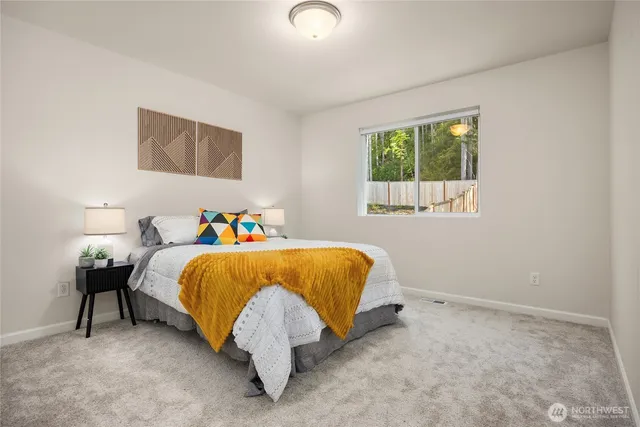 a bed sitting in a bedroom next to a window