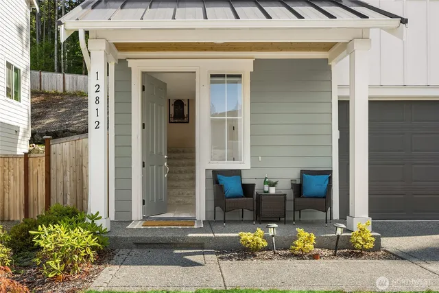 a front view of a house with outdoor seating